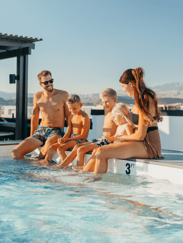 family enjoying the pool at desert color