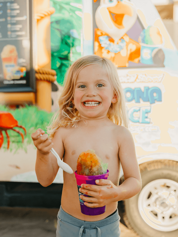 child enjoying a snowcone at desert color