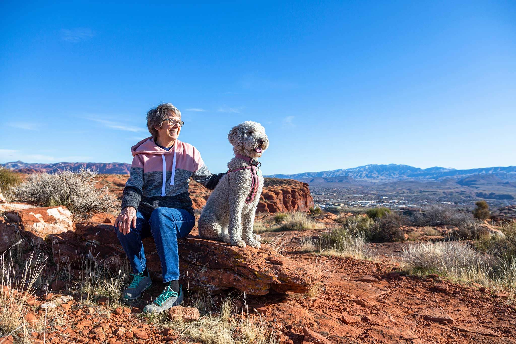 woman and dog on hike above desert color