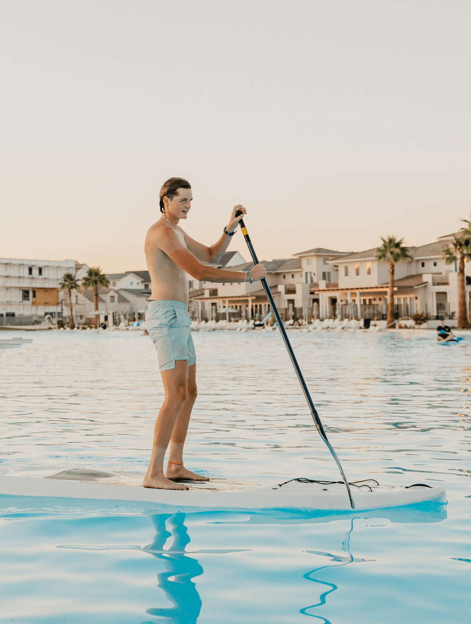 person paddle boarding on the lagoon at desert color